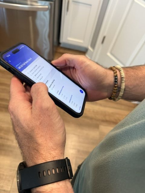Dr. Troy Goetsch reviewing a client program in the coaching app